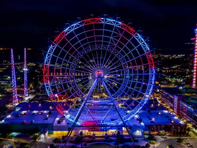 View of the entire Orlando Eye with red and blue lighting. 
